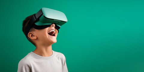 Young boy getting experience using VR headset glasses isolated on a green background with copy space