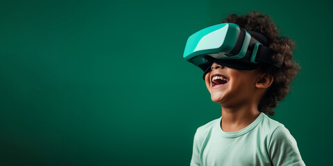 Young boy getting experience using VR headset glasses isolated on a green background with copy space