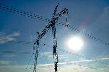 Steel pillar with high voltage electric power lines delivering electrical energy through cable wires on long distance