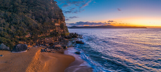 Aerial sunrise panorama over the headland, ocean, rocks and beach - Powered by Adobe
