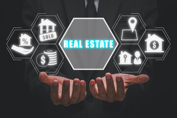 Real estate concept, Businessman hand holding real estate icon on virtual screen, Home sales and home insurance, Property insurance and security.