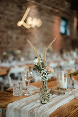 Wedding decoration with flowers and wooden tables and chairs in pastel colors 