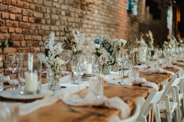 Wedding decoration with flowers and wooden tables and chairs in pastel colors 
