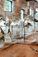 Wedding decoration with flowers and wooden tables and chairs in pastel colors 