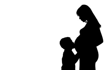 silhouette of a child kissing his pregnant mother's belly. Black and white. copy space. motherhood...