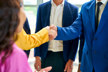 Commitment business deal concept , Hand shake by Businessman and woman and team background