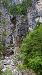 Scenic view of waterfall Cascata Cadramazzo along the Alpe Adria biking trail near Udine in Friuli-Venezia Giulia, Italy, Europe. Peaceful serene scene in Italian Alps. Remote natural landmark