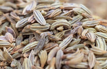 Macro of White Cumin or Jeera Seeds Isolated on Cumin Heap in Horizontal Orientation