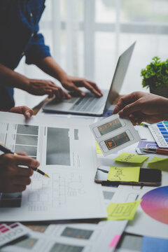 Web creative team Graphic designer planning for mobile phone choose color template draw app website ux ui for mobile application and development model Prototype outline development process.
