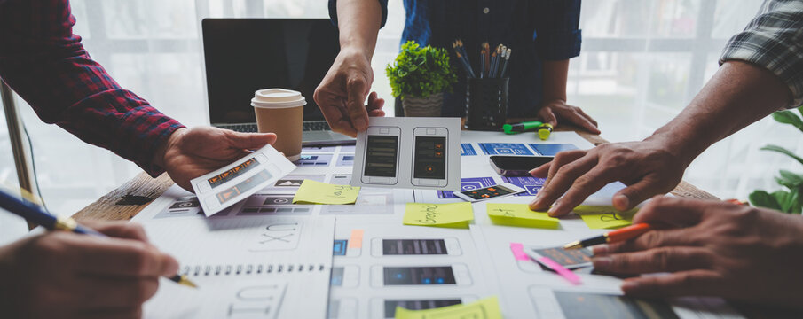 Creative business team in mobile software design project, brainstorming meeting, working together, internet technology in smartphone web part, teamwork concept, colleagues.