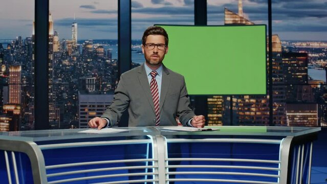 Presenter showing green screen reporting breaking news in tv channel studio.