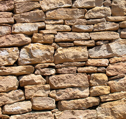 Ancient stone bricks in the wall as a background. Texture