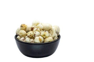 Makhana or Fox Nut in a Black Bowl Isolated on White Background with Copy Space, Also Known as Lotus Seed Pop, Euryale Ferox or Gorgon Nut
