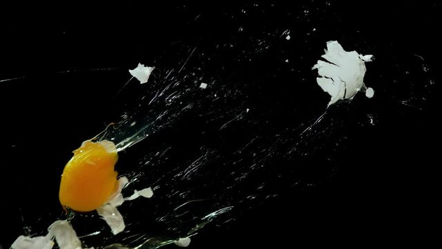 A Person Throws an Egg in Front of a Backdrop in a Studio
