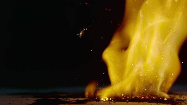 Sparks Are Ejected Away From a Pile of Burning Powder That Is Burning Vigorously