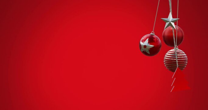 Animation of hanging baubles, tree and star swinging against red background