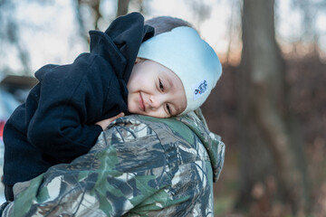 little boy in the autumn forest with his grandparents