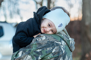 little boy in the autumn forest with his grandparents