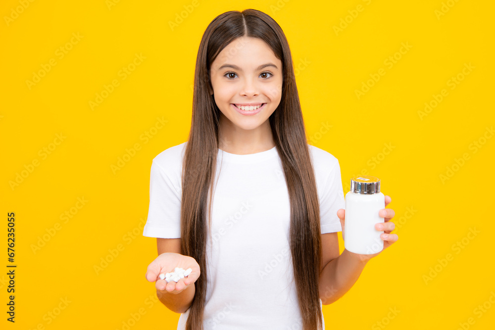 Poster staying healthy. teenage girl holding vitamin pills on yellow isolated background. happy teenager po