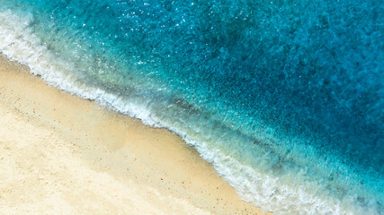 Aerial view of the beach and water on the island. During the summer the sun hits the sandy beach. Sparkling sea water. For a summer vacation idea.
