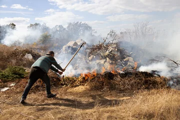 Gordijnen steppe fires during severe drought completely destroy fields. Disaster causes regular damage to environment and economy of region. The fire threatens residential buildings. Residents extinguish fire © Aleksandr Lesik