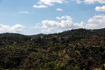 Fototapeta na wymiar Houses on the hills near Toledo and blue sky