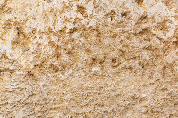 Worn stonewall background texture. Beige faded sandstone surface backdrop, empty, copy space.