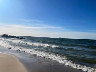 beautiful seascape with waves on the beach and blue sky