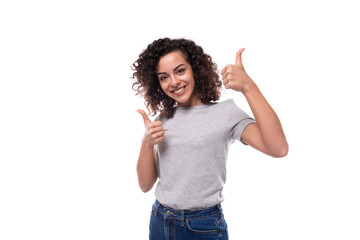 positive confident bright young european slim brunette woman with curly hair style dressed in a gray t-shirt on a white background with copy space