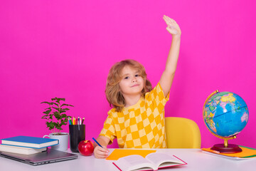 School child raising hands, willing to answer question. Nerd school kid isolated on studio...