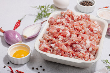 Raw minced meat, spices and herbs. Traditional ingredients for cooking cutlets or meatballs