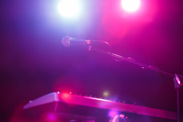 Microphone on stand on concert stage. Spotlight for a musician