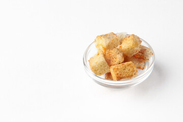 Homemade crispy croutons. Cubes of crusty bread, white fried crackers in the form of a slide. Copy space. Isolated object.