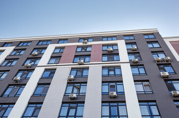 Modern apartment buildings on a sunny day with a blue sky. Facade of a modern European apartment building