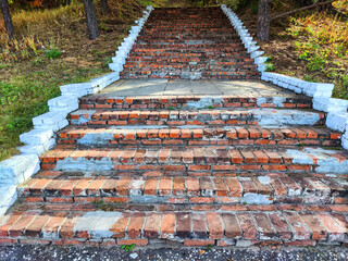 Red brick stairs. Old vintage texture stairway. Grey Grunge blocks stairs in park. Background and...