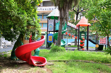 BANGKOK, THAILAND - November 10, 2023 : Colorful Playground in the park at Village in front of School, Bangkok, Thailand.