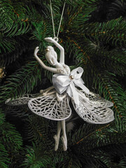 Christmas ballerina toy. Decorated Christmas tree with holiday ornaments.