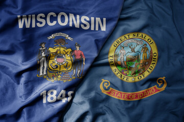 big waving colorful national flag of idaho state and flag of wisconsin state .