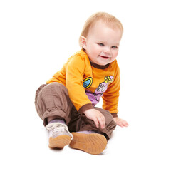 Smile, young kid and baby on floor in studio isolated on a white background mockup space. Happy child, infant and cute blonde toddler or girl in clothes, sitting or adorable, innocent and development