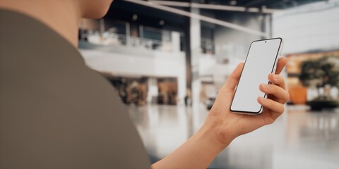 CU Caucasian male using his phone inside the car dealership
