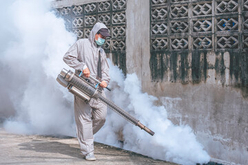 Healthcare worker using Fogging Machine Spraying chemical to eliminate Mosquitoes and prevent...
