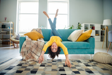 Full size photo of overjoyed cheerful lovely girl sit sofa upside down have good mood spend free...