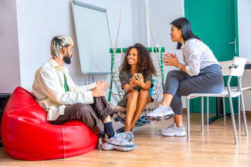 Workers chatting during a coffee break in a coworking