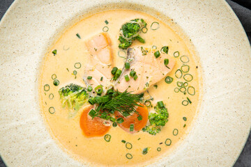soup with fish, green onions and dill, top view