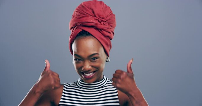 Happy woman, thumbs up and celebrate for success, winning and like emoji or fashion goals in studio. Face of excited african model or winner dance, yes hands and style agreement on a gray background