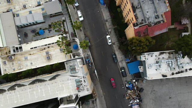 Drone shot over urban encampments and streets of the Skid Row district in LA