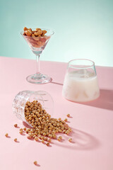 Cocktail glass contained some types nuts displayed with a cup of milk and a lot of soybeans. Soy milk supports a healthy heart from multiple angles