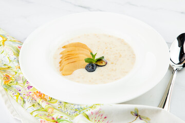 healthy breakfast with fruits in a white plate side view