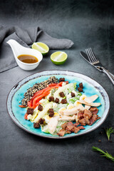different types of meat, sesame seeds, greens and croutons, side view