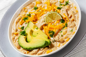 white chicken chili with cheese, avocado in bowl